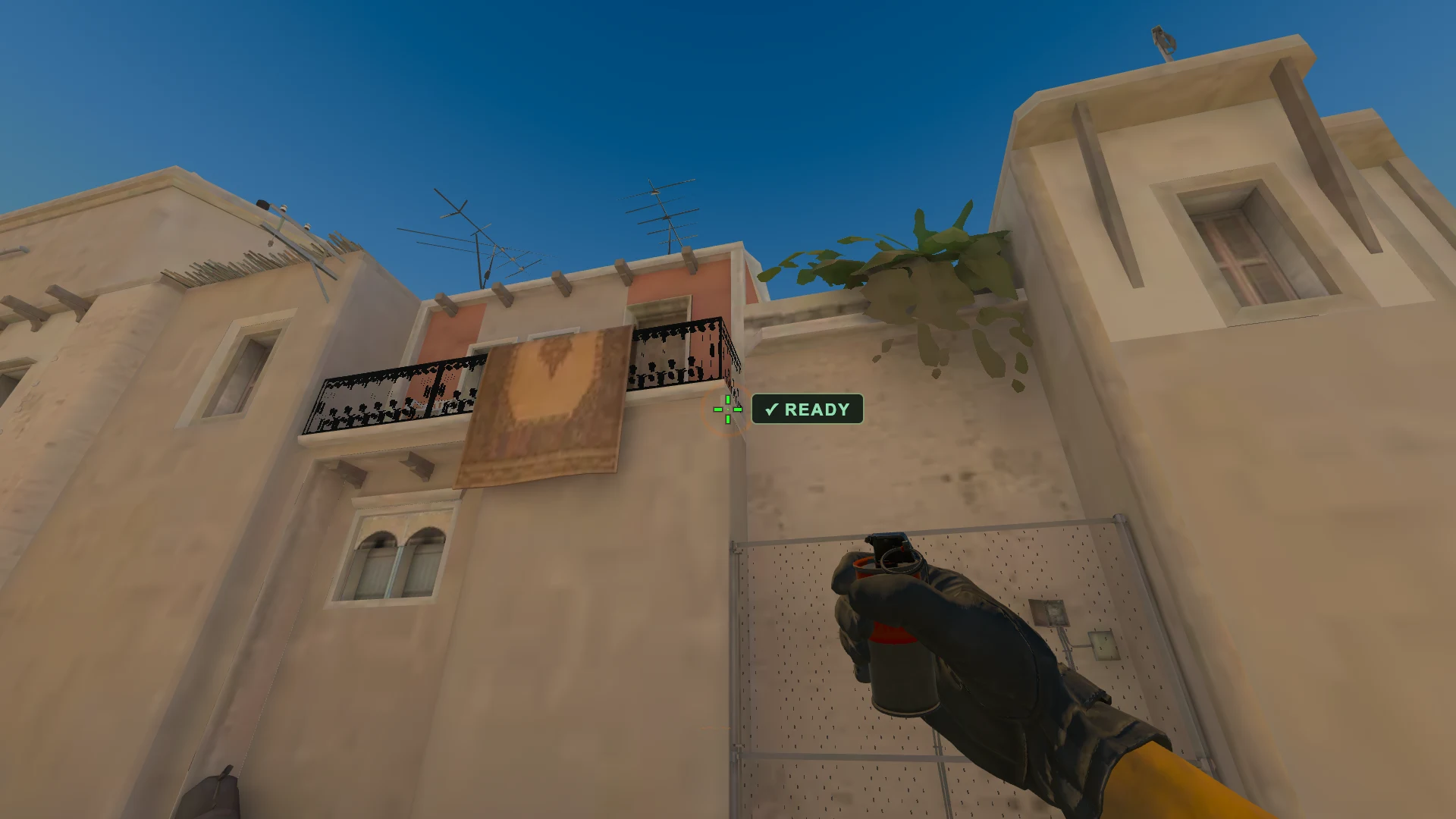 Standing on the T spawn spot on Mirage, the crosshair held on the orange ring the smoke is aimed at, a smoke grenade in hand