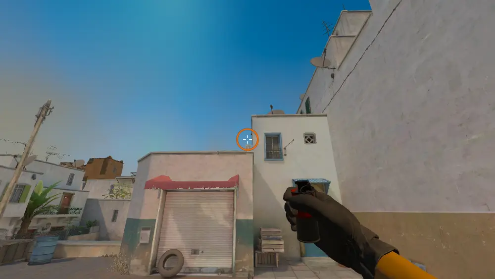 Standing on the T Spawn spot on Dust2, the aim mark on the point this smoke is thrown at.
