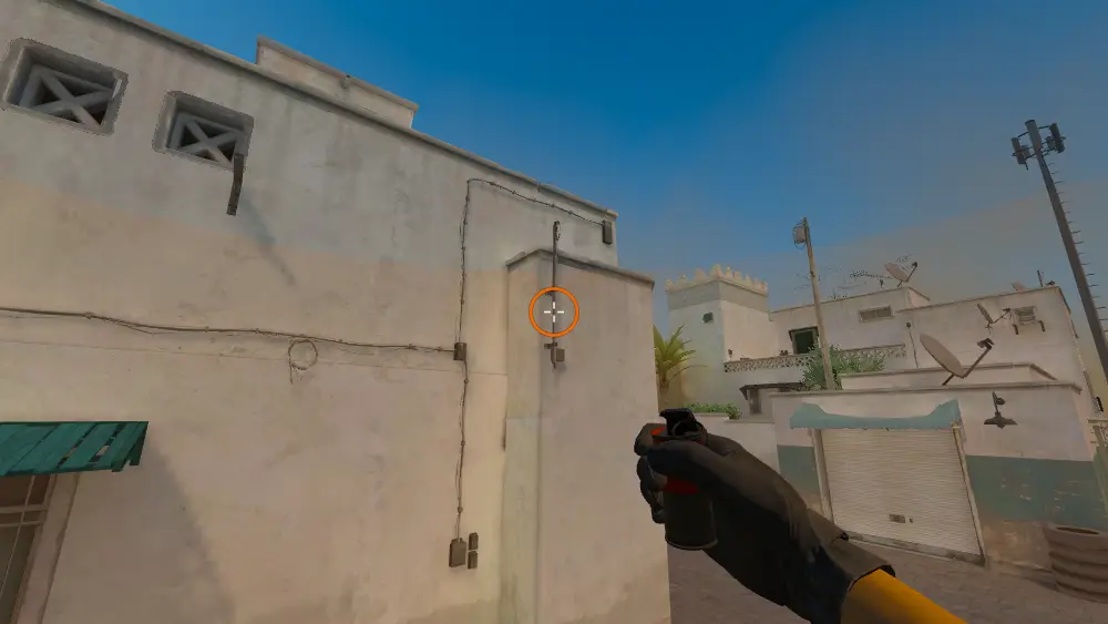 Standing on the T Spawn spot on Dust2, the aim mark on the point this smoke is thrown at.