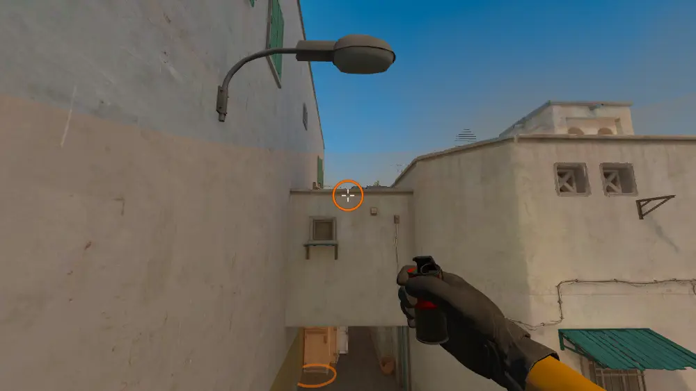 Standing on the T Spawn spot on Dust2, the aim mark on the point this smoke is thrown at.