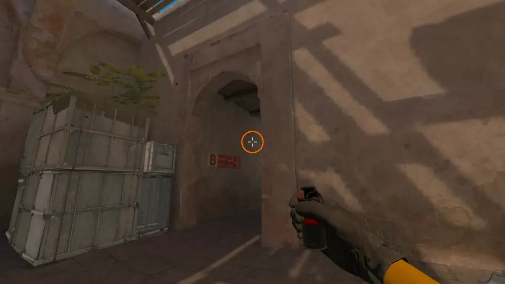 Standing on the Upper Tunnels spot on Dust2, the aim mark on the point this smoke is thrown at.