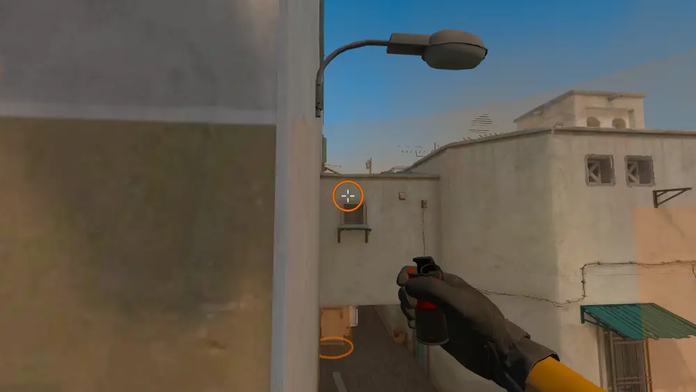 Standing on the T Spawn spot on Dust2, the aim mark on the point this smoke is thrown at.